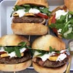 Lamb burgers with bacon & yoghurt dressing - lightly spiced lamb patties wrapped in bacon dripping in a zingy yoghurt sauce