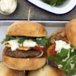 Lamb burgers with bacon & yoghurt dressing - lightly spiced lamb patties wrapped in bacon & dripping in a zingy yoghurt sauce
