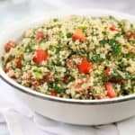 chopped tomato and parsley salad in a white bowl