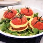 baked mozzarella tomatoes with basil pesto and rocket arugula