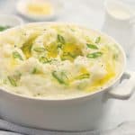 Irish Champ Potatoes - creamy mashed potatoes spiked with sliced shallots / scallions, topped with lashings of garlic butter. irish champ potatoes - creamy mashed potatoes with green onions scallions and lashings of melted butter