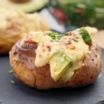 Chicken Mornay Baked Potatoes - Baked jacket potatoes loaded with a creamy mornay sauce made with leftover chicken, plus avocado, bacon & cheese.