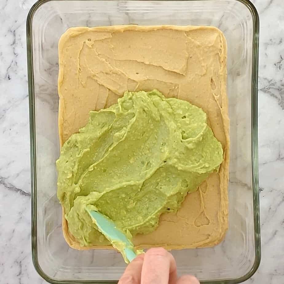 hummus and avocado in a glass dish