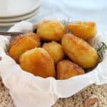 golden roasted potatoes in a white bowl