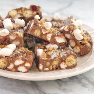 rocky road with maltesers and marshmallows on a white plate