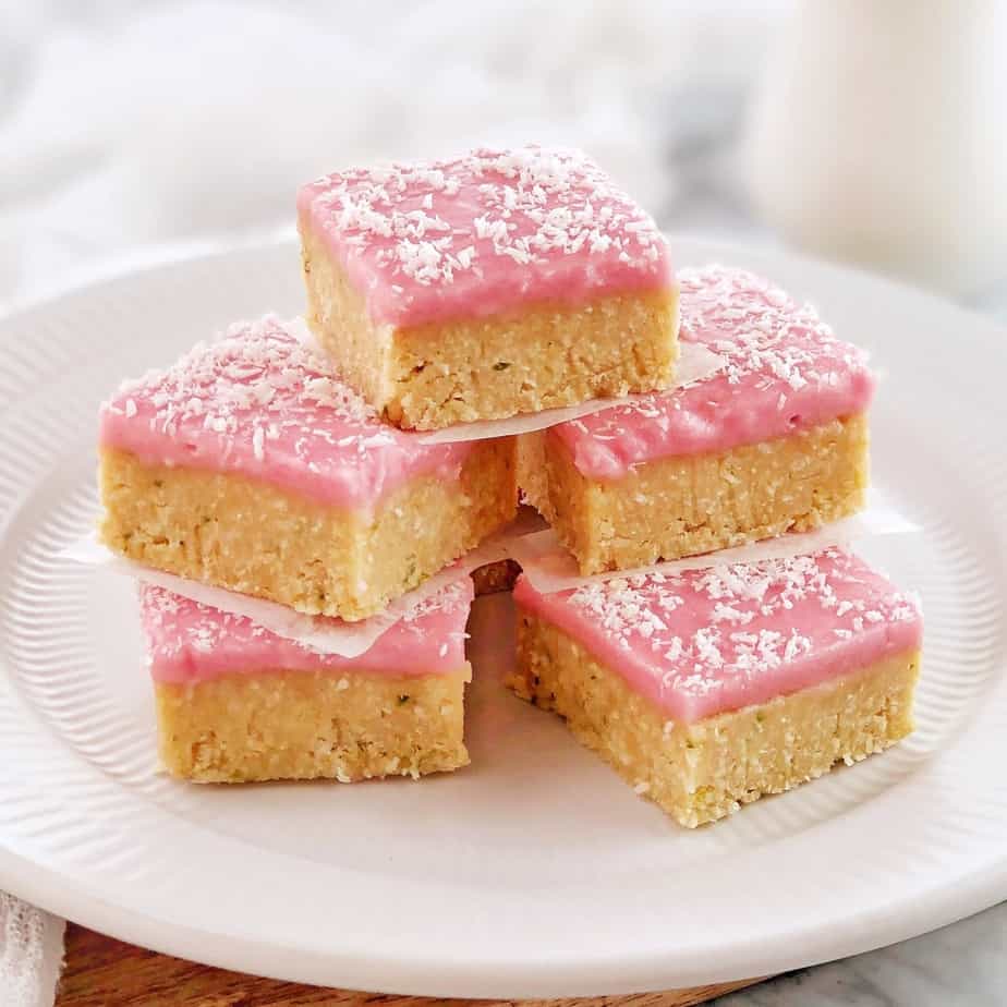 pieces of slice with pink icing on a white plate