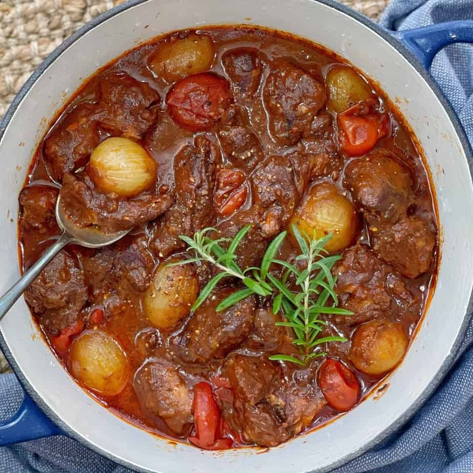 lamb and onion stew in a blue pot