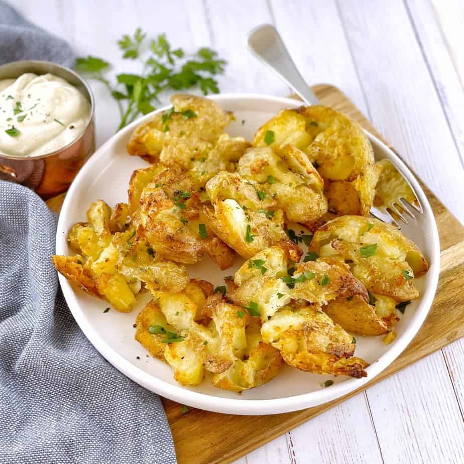 crispy chat potatoes on white plate with a fork