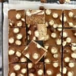 pieces of malteser slice on a wire rack with baking paper