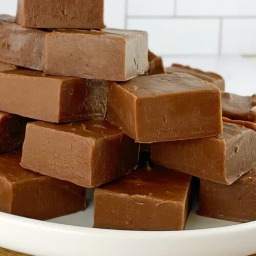 pieces of chocolate fudge on a white plate.