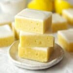 Three lemon blondies stacked on a small plate.