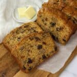Slices of date and walnut loaf on a wooden board.